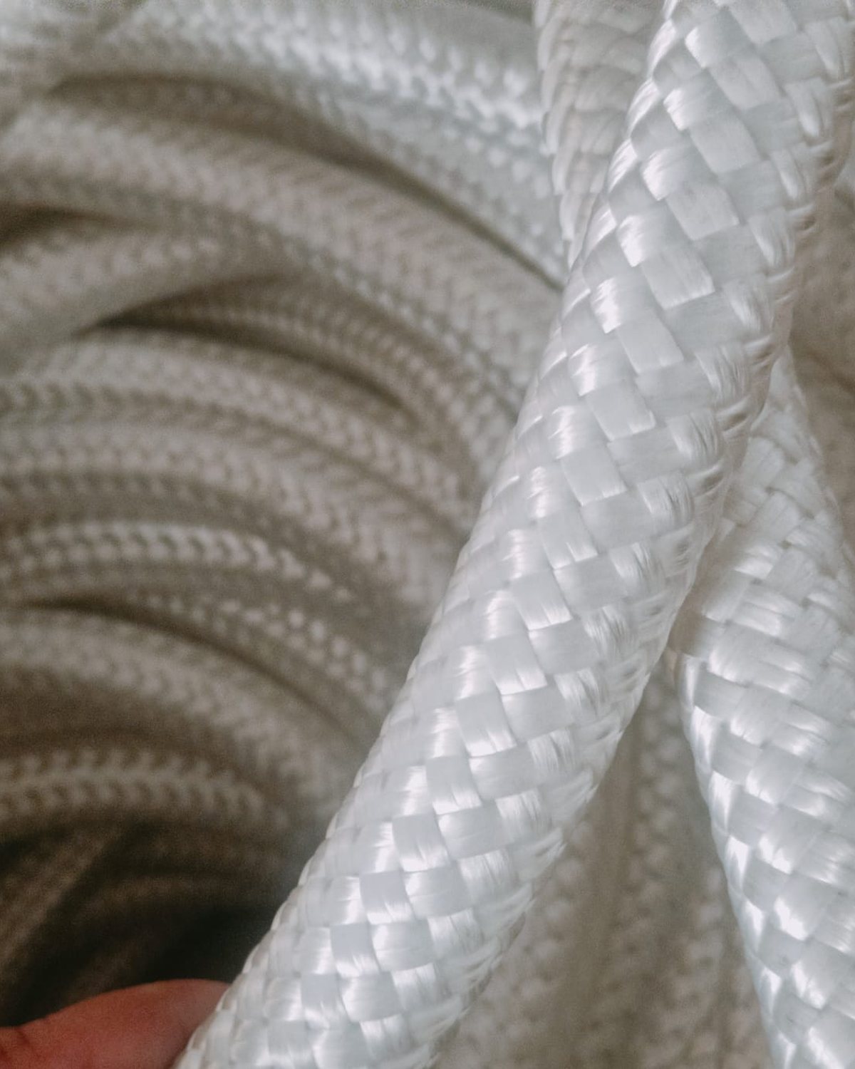 Close detail of the braided nylon jacket, unlit, coiled on the drum