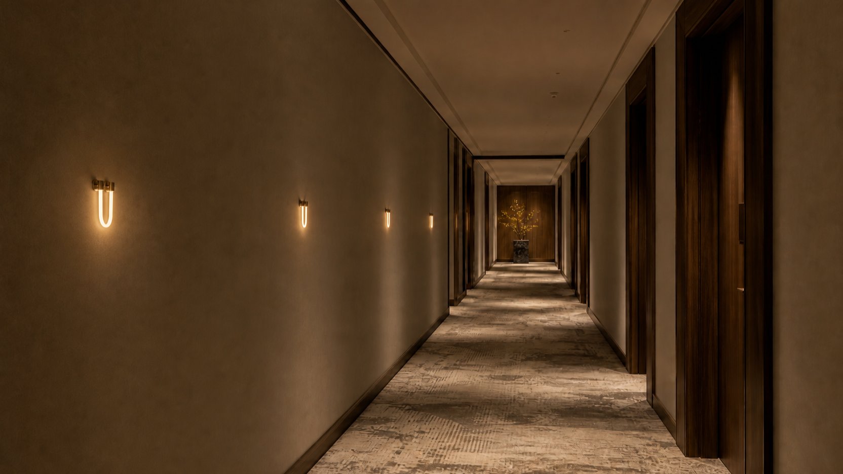 A rhythm of small Habl wall lights receding down a hotel corridor